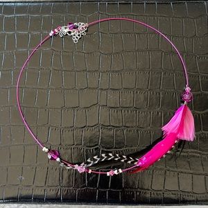 Artisan made necklace with beads and feathers